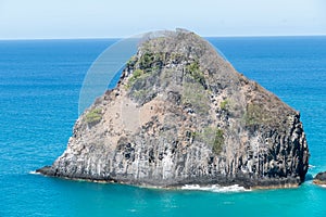 Fernando de Noronha, Brazil. View of single rock of Morro dos Dois Irmaos with crystal clear ocean