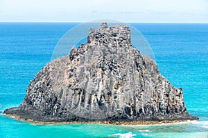 Fernando de Noronha, Brazil. View of single rock of Morro dos Dois Irmaos with crystal clear ocean