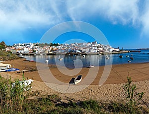 Ferragudo fishing village evening summer view with boats on water near Marina Portimao, Lagoa, Algarve, Portugal. Peoples