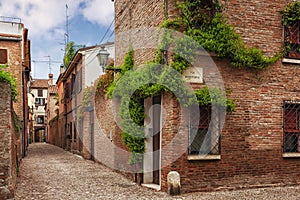 Ferrara, old narrow street, Italy