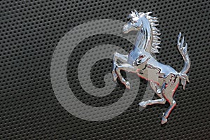 Ferrari logo on gray sport car
