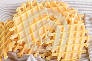 Ferratelle or pizzelle a traditional dessert or cookies from Abruzzo on a cotton napkin on light background,