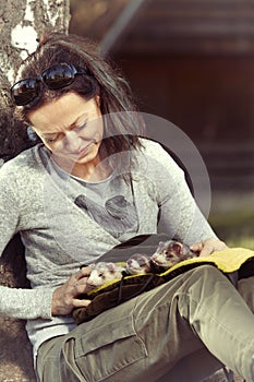 Ferret owner walking her ferrets in afternoon park