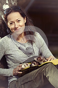 Ferret owner walking her ferrets in afternoon park