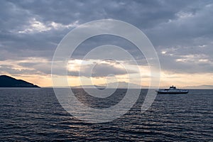 Ferries are large boats designed to transport people, vehicles, and cargo across open bodies of water, such as oceans and seas