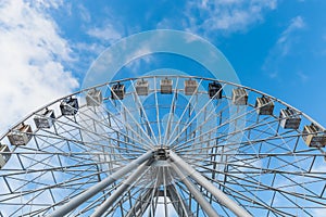 Ferris wheel against blue sky as background.