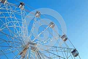 Ferris wheel against blue sky background