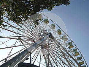 Ferris Wheel against a blue sky at a fair.