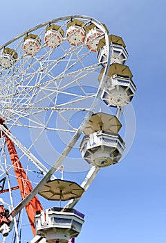 Ferris wheel against a bright blue sky