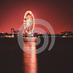 Ferris wheel amusement park at night, long exposure photography