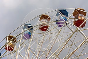 Ferris wheel in the amusement Park with storm gray clouds in the sky.