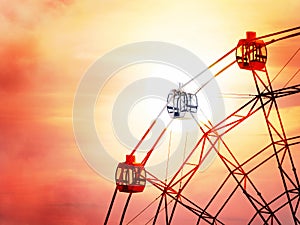 Ferris wheel in amusement Park at sunset