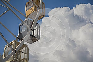 Ferris wheel on background cloudy sky