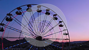 Ferris wheel on the background of the sea at sunset. View from above