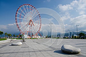 Ferris wheel on Batumi seafront with Caucasus mountains,Georgia