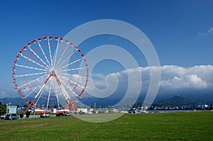 Ferris wheel on Batumi seafront with Caucasus mountains,Georgia