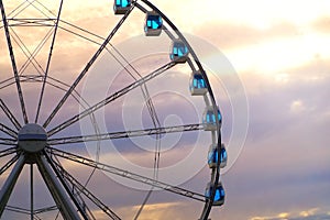A Ferris wheel with a beautiful colored cloudy sky. Ferris wheel at sunset with copy space.