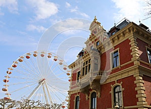 Ferris Wheel by Beautiful German Architecture with Cloudy Blue Sky in Mainz, Germany