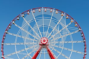 Ferris wheel on blue sky background.