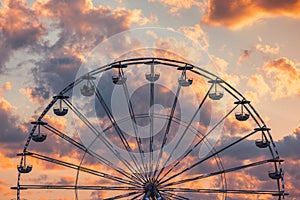Ferris Wheel with clouds in sky, dramatic sunset cloudscape