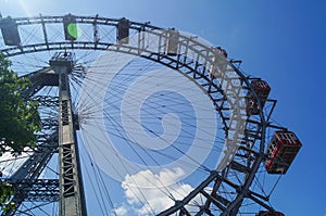Ferris wheel blue sky clouds and sun