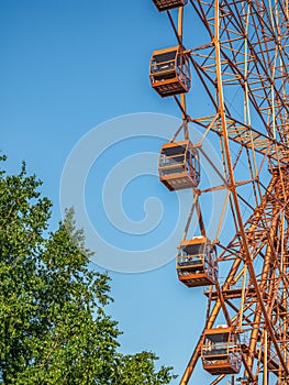 Ferris wheel booths on a background of blue sky, bottom view