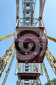 Ferris wheel cabin close-up against blue sky