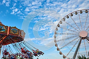 Ferris wheel and carousel in motion blur at Oktoberfest in Munich