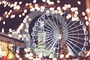 Ferris wheel on the Christmas market. Out of focus, the lights of the night city.