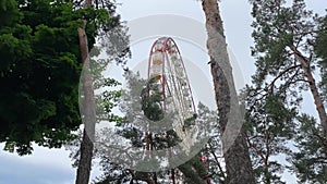 Ferris Wheel in city park, amusement park Kharkov, Ukraine, rainy day 4k video