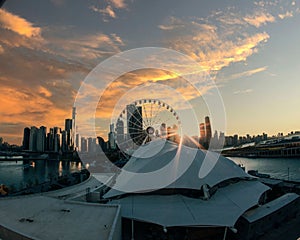 Ferris wheel with city skyline against sunset at Navy Pier,Chicago