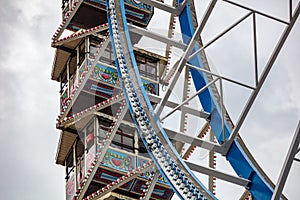 Ferris wheel closeup detail view on cloudy sky. Oktoberfest, Bavaria, Germany