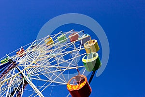 A ferris wheel with colorful cabins