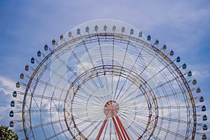 A ferris wheel with colorful cabins at a local fun fair