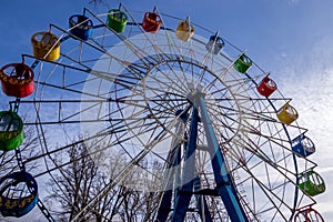 Ferris wheel with colorful cabs against the sky