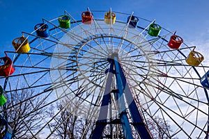 Ferris wheel with colorful cabs against the sky