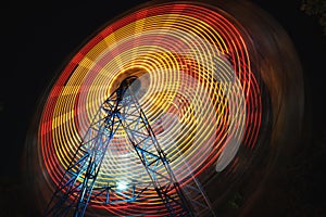 Ferris Wheel at county fair at night, motion blurred