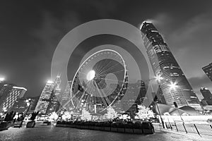 Ferris Wheel in downtown of Hong Kong city at dusk