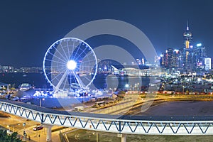 Ferris Wheel in downtown of Hong Kong city at night