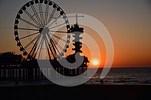 Ferris Wheel In the evening on the beach sunset