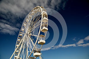 Ferris Wheel at a Fairground Against a Clear Blue Sky