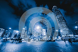 The ferris wheel, Hong Kong Observation Wheel at night, and amusement park for kids in holiday vacation and travel trip concept.