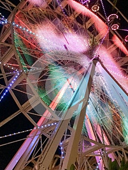 Ferris wheel illuminated at night colorful light motion