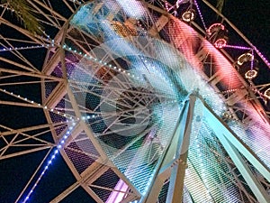 Ferris wheel illuminated at night colorful light motion