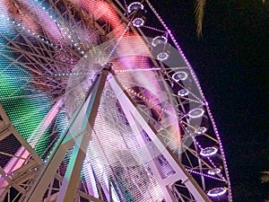 Ferris wheel illuminated at night colorful light motion