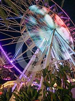 Ferris wheel illuminated at night colorful light motion