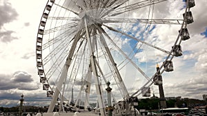 Ferris wheel installed Place de la Concorde near the Tuileries Garden in Paris, with the Eiffel to