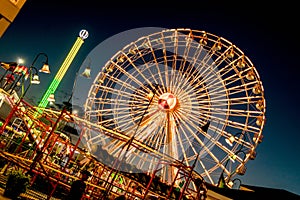 Ferris wheel lighting twighlight sky.