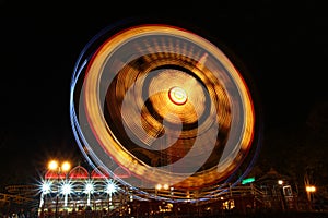 Ferris Wheel in motion illuminated at night