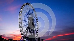 Ferris wheel in motion at sunset time